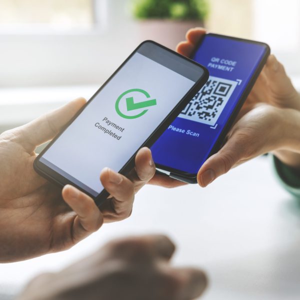 qr code payment - person paying with mobile phone